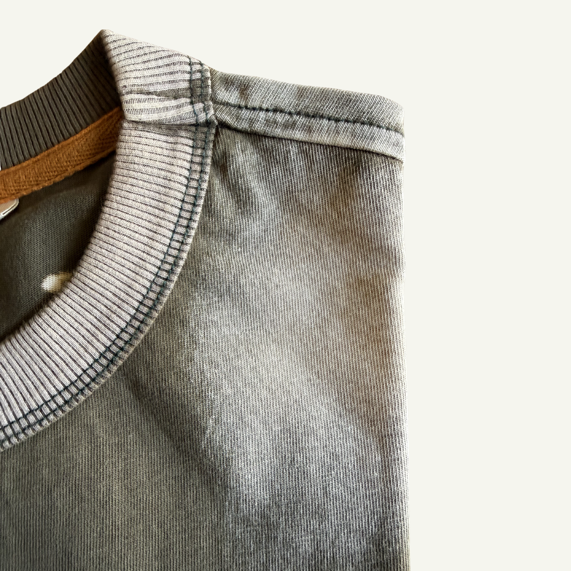 Close-up of a green distressed collar on a light gray background