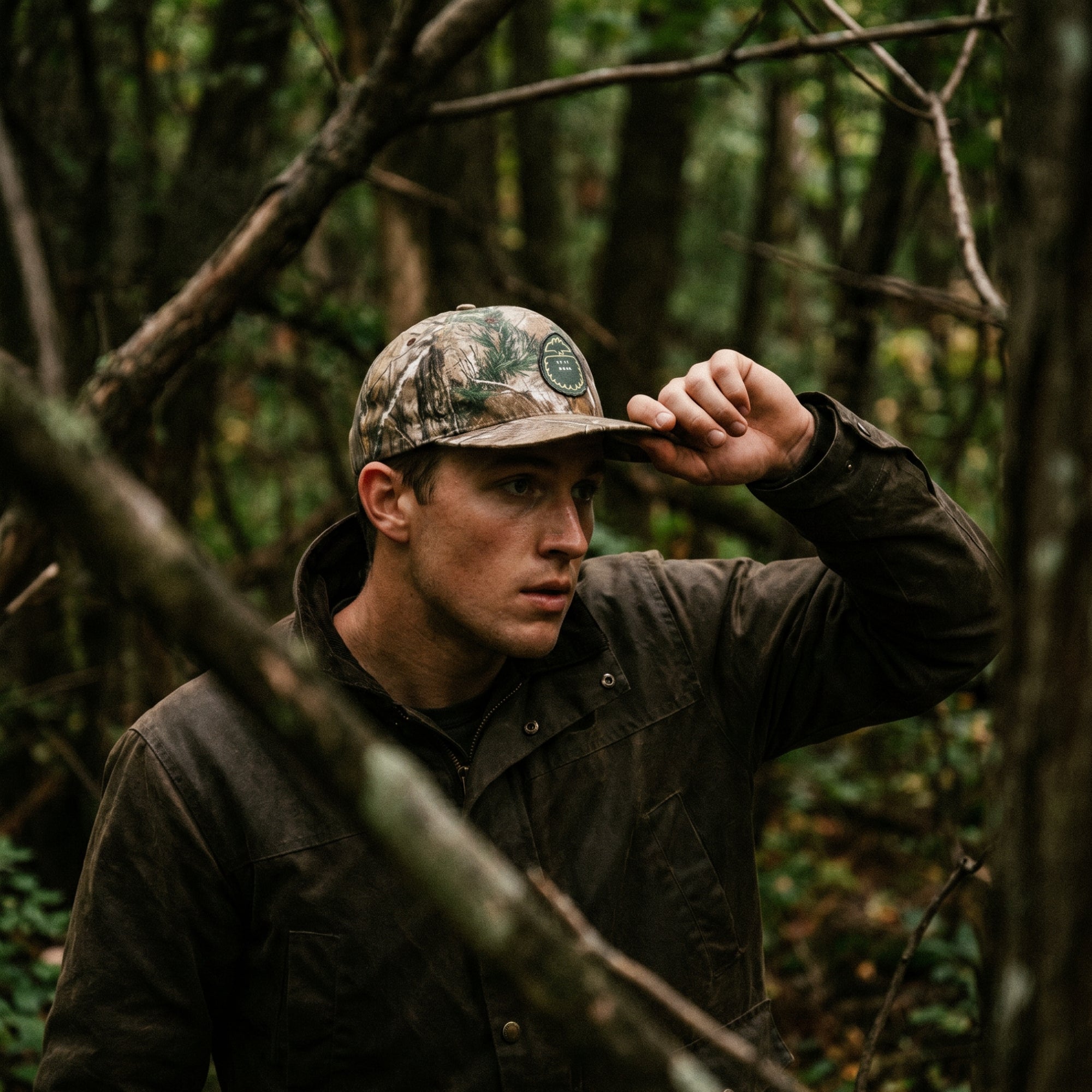 man in forest wearing bigfoot patch camo hat from Bigfoot Kick