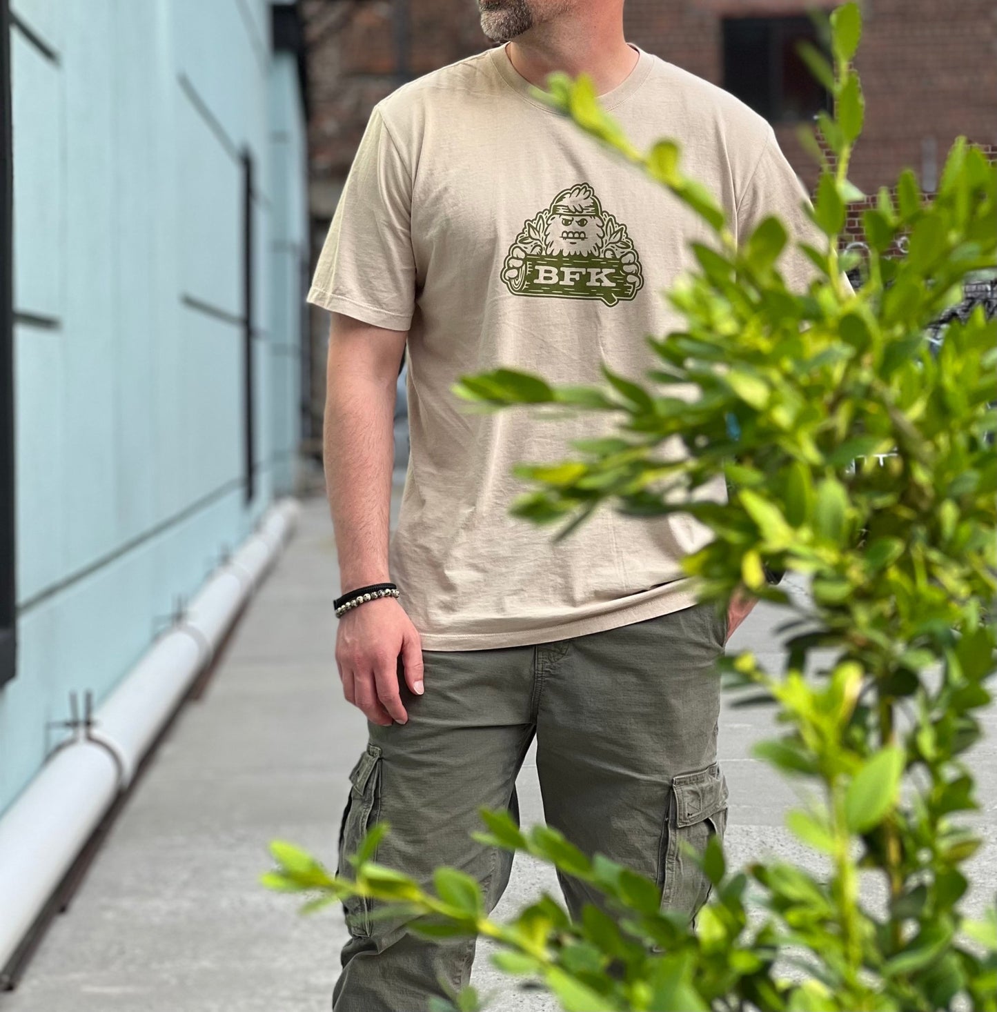 Camp Bigfoot T-Shirt in Latte - Bigfoot Kick