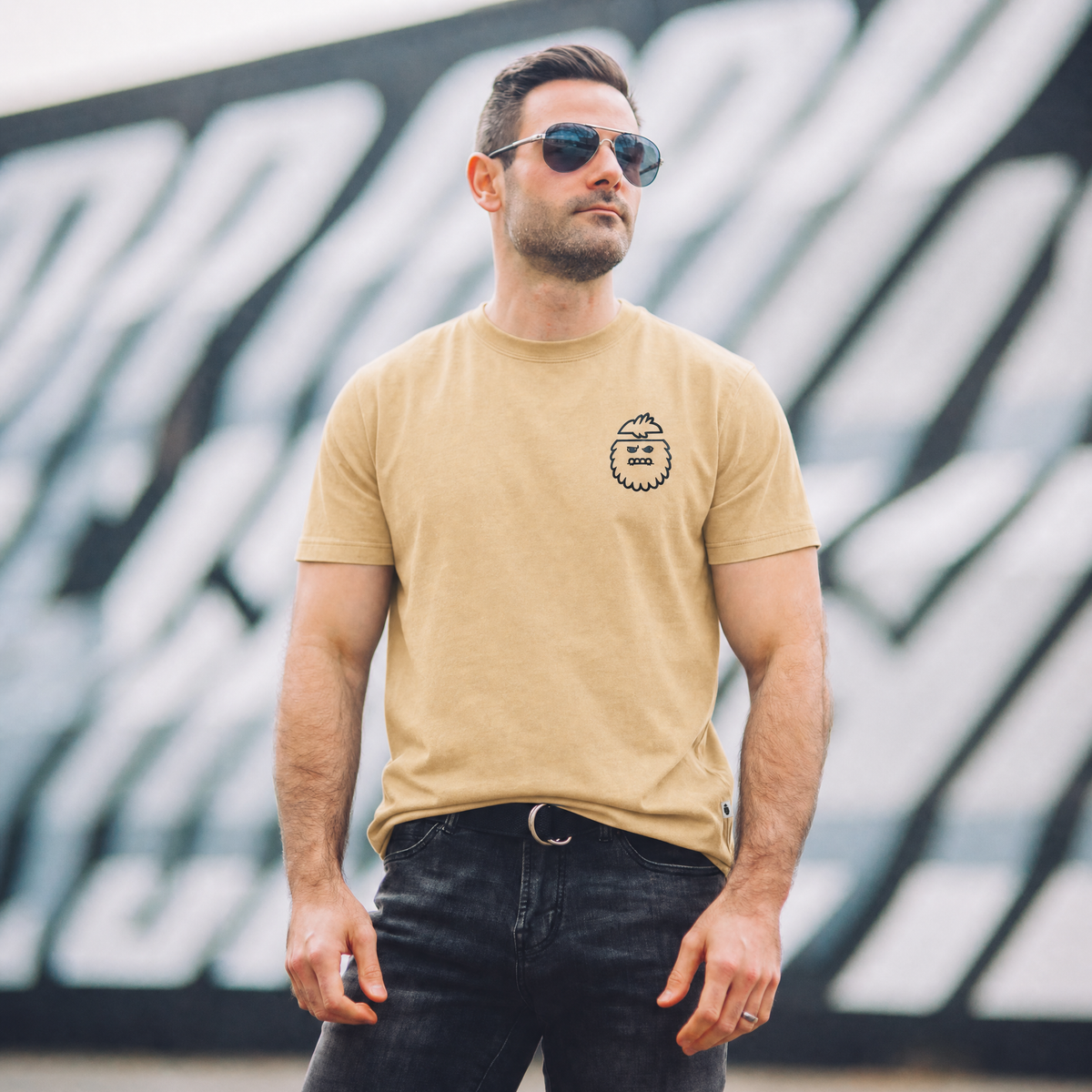 Man wearing a vintage orange tee shirt with bigfoot logo by Bigfoot Kick